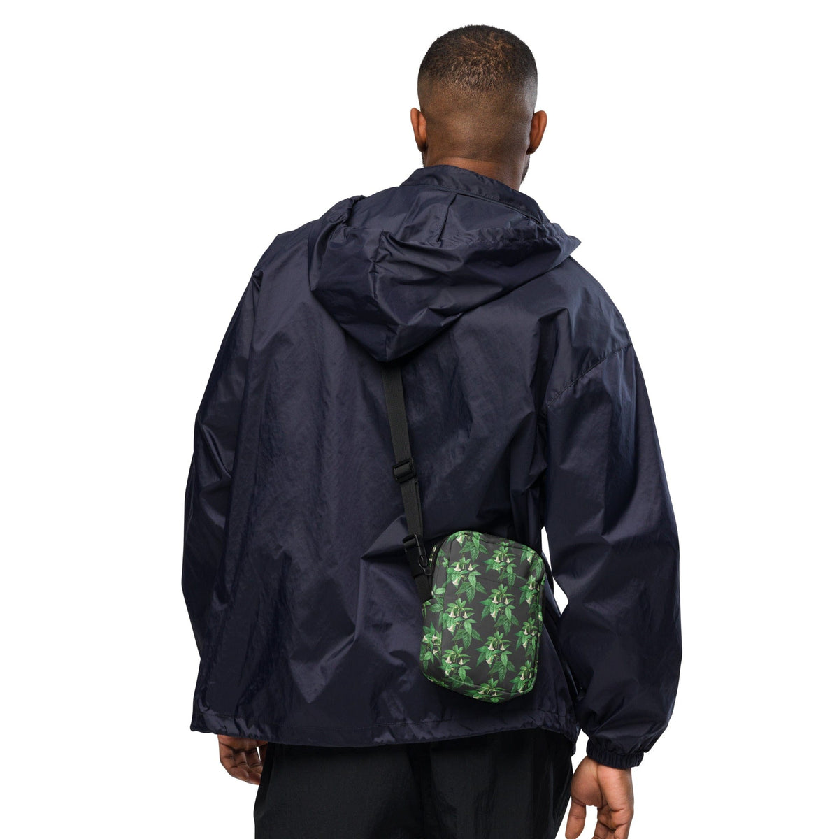 Small crossbody bag, green floral print, black zipper, worn at chest