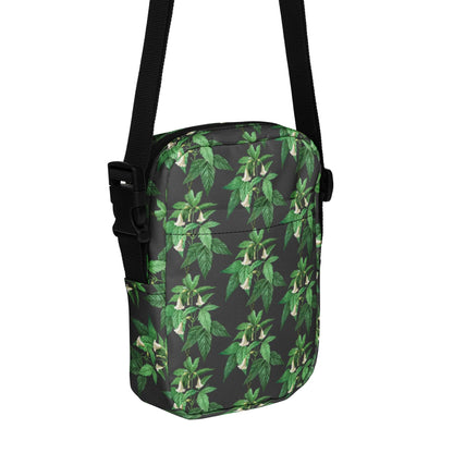 Utility crossbody bag with green leaf floral print, black shoulder strap and buckle