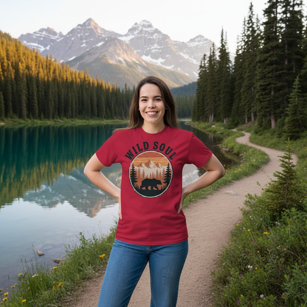 Model wearing red bear camping graphic t-shirt with circular Wild Soul logo