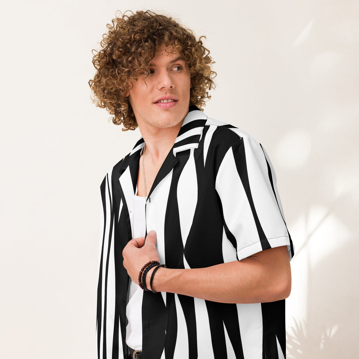 Zebra print short-sleeve button-up shirt with black and white vertical stripes, open collar